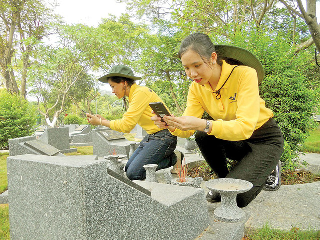 Young people take photos of martyr tombstone to provide online data