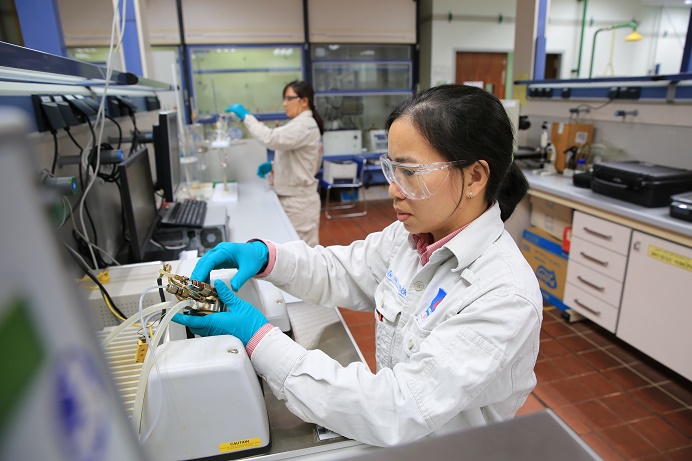 Female oil refinery engineer with passion for work