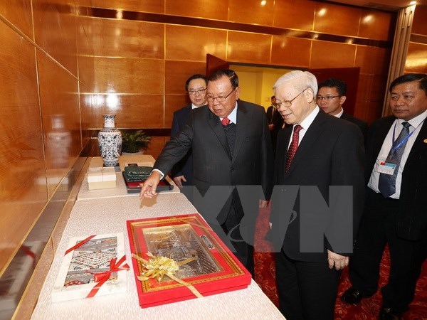 Nguyen Phu Trong et Bounnhang Vorachith à une exposition sur les relations Vietnam-Laos