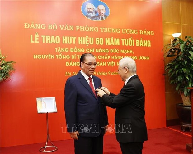 60-year Party membership badge presented to former Party chief Nong Duc Manh