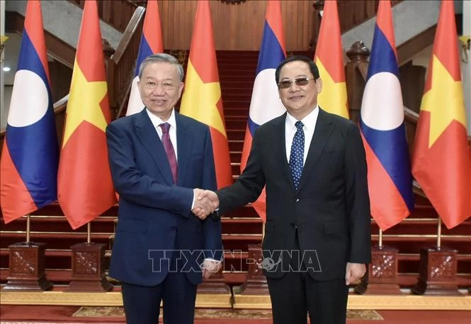President To Lam meets Lao Prime Minister